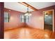 Bright dining room with hardwood floors and mauve walls features a unique, hanging light fixture at 5010 45Th N Ave, St Petersburg, FL 33709