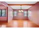 Bright dining room with hardwood floors, mauve walls, statement lighting, and many windows at 5010 45Th N Ave, St Petersburg, FL 33709