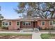 Charming brick home with a metal roof, landscaped yard and mature trees at 5010 45Th N Ave, St Petersburg, FL 33709