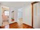 Hallway showcasing pristine hardwood floors connecting various rooms in the home at 5010 45Th N Ave, St Petersburg, FL 33709