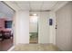 Hallway view with a bathroom, an open doorway, and a painted utility door at 5010 45Th N Ave, St Petersburg, FL 33709