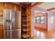 This kitchen features wood cabinets, stainless steel refrigerator, and a pull out pantry at 5010 45Th N Ave, St Petersburg, FL 33709