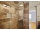 Beautifully tiled shower with glass enclosure, recessed lighting, and travertine wall accents at 5010 45Th N Ave, St Petersburg, FL 33709