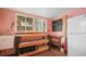 A utility room with a large window, sink, wood work bench, and salmon colored walls at 5010 45Th N Ave, St Petersburg, FL 33709