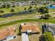 Aerial shot of a charming home with a well-manicured lawn and a paved driveway at 607 Fox Hills Dr, Sun City Center, FL 33573