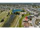 Aerial view of home in a beautiful community with ponds and a golf course at 607 Fox Hills Dr, Sun City Center, FL 33573