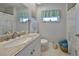 Bathroom featuring a shower with tub, granite counters, and a window for natural light at 607 Fox Hills Dr, Sun City Center, FL 33573