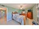 Bedroom with comfortable bed, fan, TV, dresser, and doorway to Primary bathroom at 607 Fox Hills Dr, Sun City Center, FL 33573