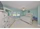 Cozy bedroom featuring a white bed, a matching dresser, and a decorative mirror at 607 Fox Hills Dr, Sun City Center, FL 33573