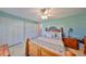 Bedroom with light-colored walls, vintage-style dresser, two closets, and a fan at 607 Fox Hills Dr, Sun City Center, FL 33573