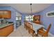 Bright dining room with tile flooring and direct view of the granite countertops and kitchen appliances at 607 Fox Hills Dr, Sun City Center, FL 33573