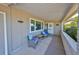 Inviting front porch with seating area for relaxing in front of the house at 607 Fox Hills Dr, Sun City Center, FL 33573
