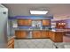 Bright kitchen with light-colored cabinets, stainless steel appliances, granite countertops, and stylish tile flooring at 607 Fox Hills Dr, Sun City Center, FL 33573