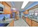 Updated kitchen boasts granite countertops, stainless steel appliances, tile floors, and wood cabinets at 607 Fox Hills Dr, Sun City Center, FL 33573