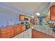 Spacious kitchen equipped with stainless steel appliances, granite counters, and ample cabinet storage at 607 Fox Hills Dr, Sun City Center, FL 33573