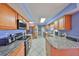 Well-lit kitchen features light-colored wood cabinets, stainless steel appliances, and granite countertops at 607 Fox Hills Dr, Sun City Center, FL 33573