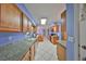 Modern kitchen design with granite counters, stainless appliances, tile flooring, and wooden cabinetry at 607 Fox Hills Dr, Sun City Center, FL 33573