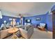 Spacious living room with modern furniture, stylish rug, and bright blue walls at 607 Fox Hills Dr, Sun City Center, FL 33573