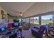 Bright sunroom features lots of natural light, comfortable seating, and views of the backyard at 607 Fox Hills Dr, Sun City Center, FL 33573