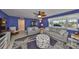 Bright living room with neutral furniture, ceiling fan, and a large window at 607 Fox Hills Dr, Sun City Center, FL 33573