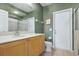 Neutral bathroom featuring a vanity, toilet, shower and decorative mirror at 6109 Kingbird Manor Dr, Lithia, FL 33547