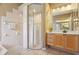 Bright bathroom featuring a glass enclosed shower, vanity and garden tub at 6109 Kingbird Manor Dr, Lithia, FL 33547
