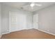 Cozy bedroom features a ceiling fan and a double door closet at 6109 Kingbird Manor Dr, Lithia, FL 33547