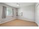 Empty room with a window, carpet and ceiling fan, perfect for a bedroom or office at 6109 Kingbird Manor Dr, Lithia, FL 33547