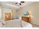 Bright bedroom features trey ceiling with ceiling fan, neutral colored walls, and wood furniture at 6109 Kingbird Manor Dr, Lithia, FL 33547