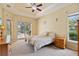 Bedroom with ceiling fan and direct access to a screened pool and outdoor entertainment area at 6109 Kingbird Manor Dr, Lithia, FL 33547