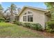 Exterior shot showcasing stucco siding, beautiful windows, manicured lawn, and screened porch at 6109 Kingbird Manor Dr, Lithia, FL 33547
