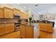 Open kitchen with wood floors, central island, stainless steel appliances, and granite countertops at 6109 Kingbird Manor Dr, Lithia, FL 33547
