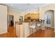 Kitchen island with bar stool seating and connecting access to other rooms at 6109 Kingbird Manor Dr, Lithia, FL 33547