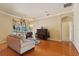 Bright living room featuring hardwood floors, a cozy seating area, and direct access to the screened-in patio and pool at 6109 Kingbird Manor Dr, Lithia, FL 33547