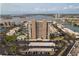 Aerial view of building showing parking, pool, surrounding waterways and landscape at 7300 Sun Island S Dr # 202, South Pasadena, FL 33707