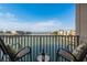 Balcony with two chairs has beautiful water views perfect for relaxing with a drink at 7300 Sun Island S Dr # 202, South Pasadena, FL 33707