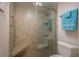 Modern bathroom with glass enclosed shower, built-in seat, and tiled walls at 7300 Sun Island S Dr # 202, South Pasadena, FL 33707
