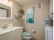 Updated bathroom with modern vanity, decorative shelving, and convenient washer/dryer combo for easy living at 7300 Sun Island S Dr # 202, South Pasadena, FL 33707
