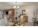 Dining room features a modern chandelier, glass table, and stylish decor at 7300 Sun Island S Dr # 202, South Pasadena, FL 33707
