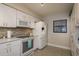Bright kitchen with stainless steel oven, microwave, fridge and white cabinets at 7300 Sun Island S Dr # 202, South Pasadena, FL 33707
