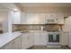 Corner view of a well-equipped kitchen featuring modern appliances and an island with seating at 7300 Sun Island S Dr # 202, South Pasadena, FL 33707