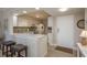 Open kitchen with breakfast bar, white cabinets, and stainless steel appliances at 7300 Sun Island S Dr # 202, South Pasadena, FL 33707