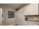 Well-lit kitchen with white cabinets and countertop appliances, offering ample storage at 7300 Sun Island S Dr # 202, South Pasadena, FL 33707