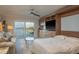 Open floorplan with large sliding glass doors to balcony with water views, murphy bed, and stylish furnishings at 7300 Sun Island S Dr # 202, South Pasadena, FL 33707