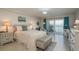 Bright main bedroom with balcony access, water views, and neutral decor at 7300 Sun Island S Dr # 202, South Pasadena, FL 33707