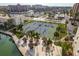 Aerial view showcasing the community tennis courts, tiki huts, landscaping and waterfront location at 7300 Sun Island S Dr # 202, South Pasadena, FL 33707