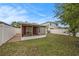 An exterior view shows the fenced backyard with a covered patio area at 7924 Carriage Pointe Dr, Gibsonton, FL 33534