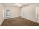 Large carpeted bedroom with ceiling fan, closet, and an ensuite bathroom featuring a glass enclosed shower at 7924 Carriage Pointe Dr, Gibsonton, FL 33534