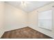 Bright carpeted bedroom with a ceiling fan and a large window at 7924 Carriage Pointe Dr, Gibsonton, FL 33534