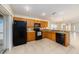 Well-lit kitchen with granite countertops, black appliances, and tile flooring at 7924 Carriage Pointe Dr, Gibsonton, FL 33534